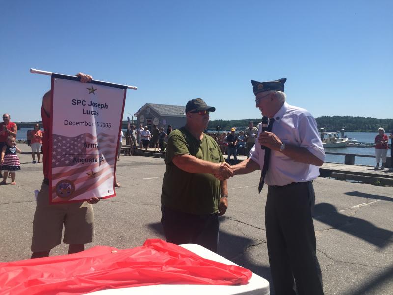 Jeffrey Lucas of Edgecomb shakes hands with Cossette and accepts a Gold Star banner honoring son Joseph Lucas. SUSAN JOHNS/Wiscasset Newspaper