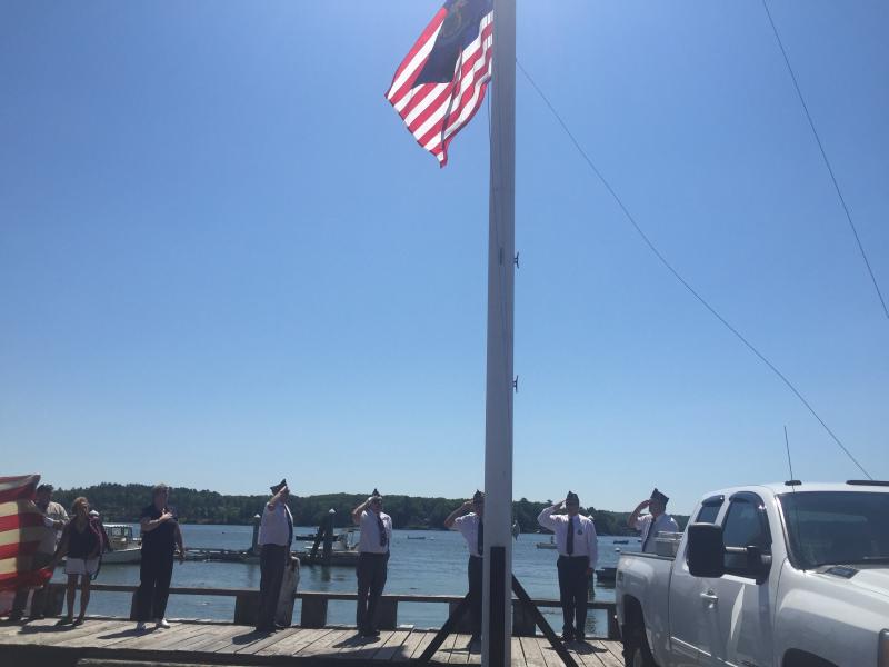 American Legion Post 54 members salute at a flag-raising on the waterfront. SUSAN JOHNS/Wiscasset Newspaper