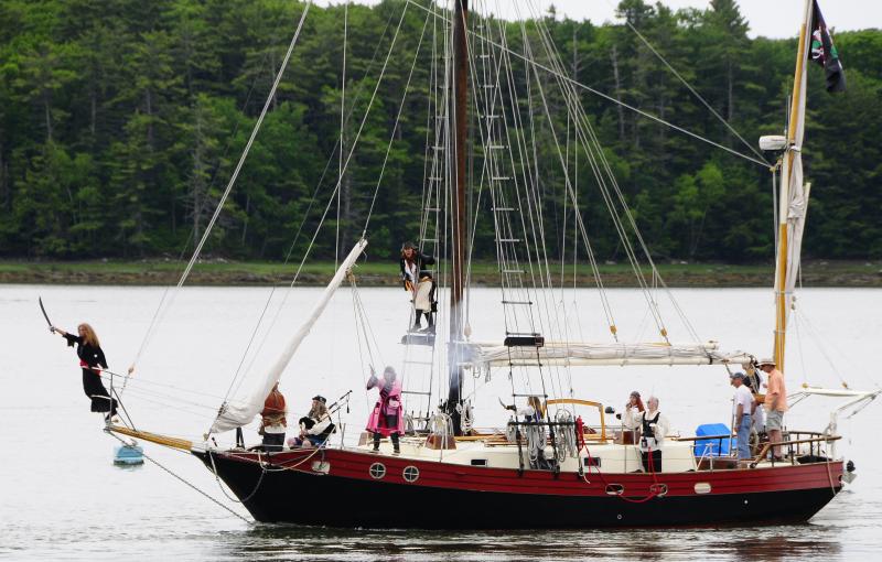 Pirate Vessel Must Roos: The pirate vessel Must Roos leads the attack on the Twin Villages during a past Pirate Rendezvous. “Must Roos” is Estonian for “Dark Rose,” the symbol of the Dark Rose Pirates. Courtesy of easternmaineimages.com