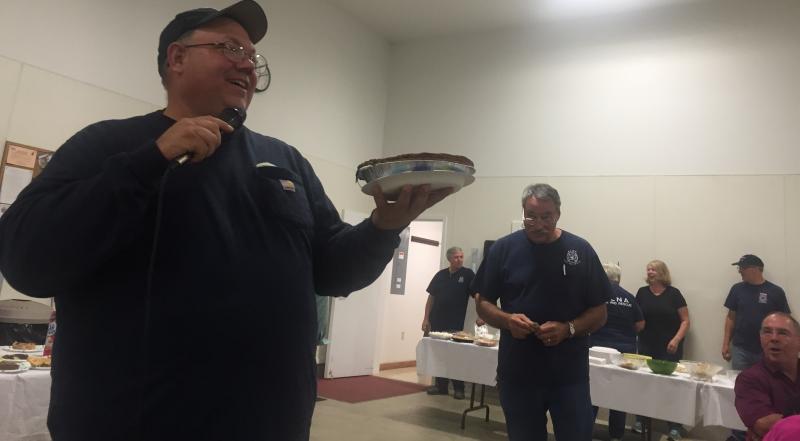 Alna Fire Chief Mike Trask auctions off pies Saturday night with Assistant Chief Roger Whitney, right, nearby. SUSAN JOHNS/Wiscasset Newspaper