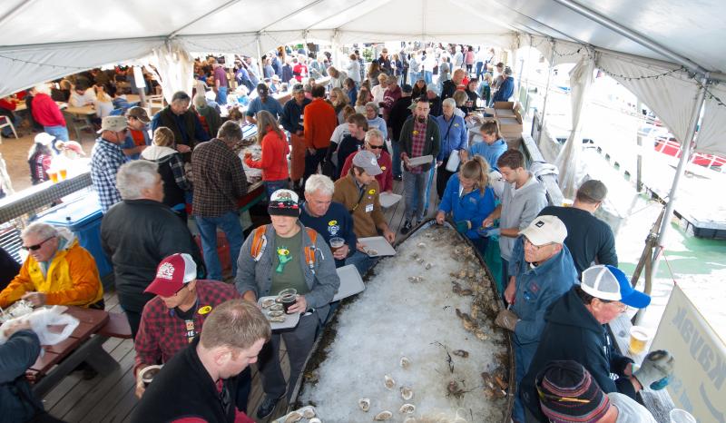 Guests at a past Pemaquid Oyster Festival enjoy oysters fresh from the Damariscotta River under the cover of a tent provided by Renys. The tent allows the festival to go regardless of weather conditions. This year the Pemaquid Oyster Festival is scheduled for Sunday, Sept. 30 from noon to dusk. Courtesy of Scott B. Smith