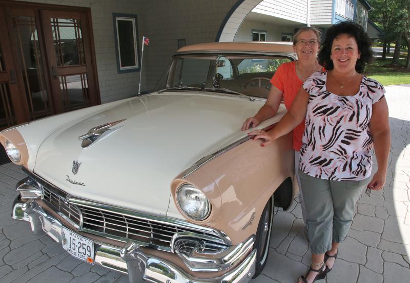 Karen Westhaver, front, executive director of Schooner Cove Retirement Community and Wanda Wilcox, executive director of Chase Point Assisted Living, pose with a 1956 Ford Fairlane, one of the many antique cars on display at the sixth annual Antique Car Show and Elvis Extravaganza Aug. 13. Courtesy of LincolnHealth