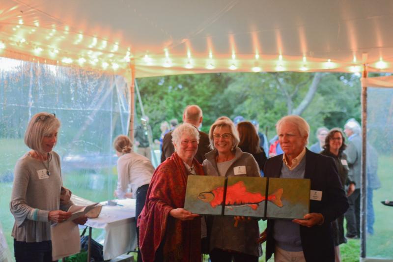 Raffle winners Ellin and Stephen Sheehy with artist Kate Nordstrom. Courtesy of Midcoast Conservancy