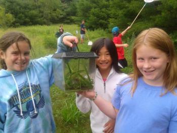 Boothbay Region Land Trust’s environmental educator Tracey Hall provides free environmental education programs to the community including the land trust’s partners. Camp Knickerbocker campers, from left, Mattie, Annalise and Zoey participate in Hall’s wilderness camp and show off a green frog found far from the water during a habitat exploration at Zak Preserve. BRLT is raising endowment to sustain Tracey’s role and the land trust’s Osprey Program. Courtesy of BRLT