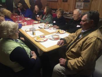 Chamber members talk in a museum building before the ride. SUSAN JOHNS/Wiscasset Newspaper