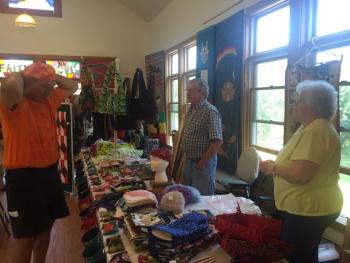 David Casada, left, of West Bath, adjusts some head wear and meets with Hector and Arline Berube of Old Orchard Beach. SUSAN JOHNS/Wiscasset Newspaper