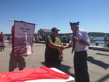 Jeffrey Lucas of Edgecomb shakes hands with Cossette and accepts a Gold Star banner honoring son Joseph Lucas. SUSAN JOHNS/Wiscasset Newspaper